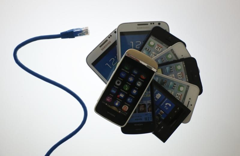 © Reuters. An illustration picture shows a network cable next to a pack of smartphones in Berlin