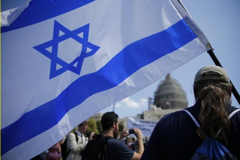 © Reuters. An activist carrying an Israeli flag gathers at a Capitol Hill rally to "Stop the Iran Nuclear Deal" in Washington