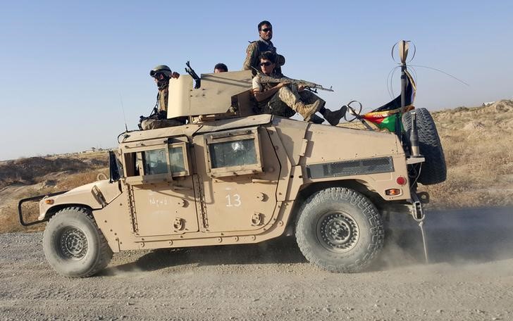 © Reuters. File photo of Afghan security forces sitting on top of a vehicle as they patrol outside of Kunduz city