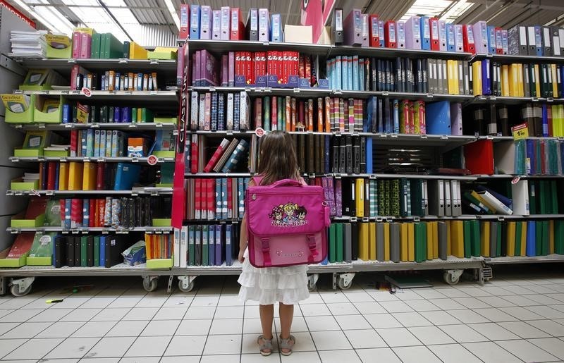 © Reuters. A young girl looks at school at school stationery in a supermarket in Nice