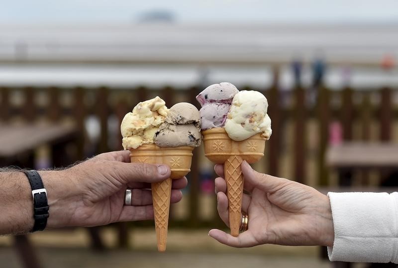© Reuters. A couple pose with their ice creams on the sea front at Weston Super Mare in south-west England