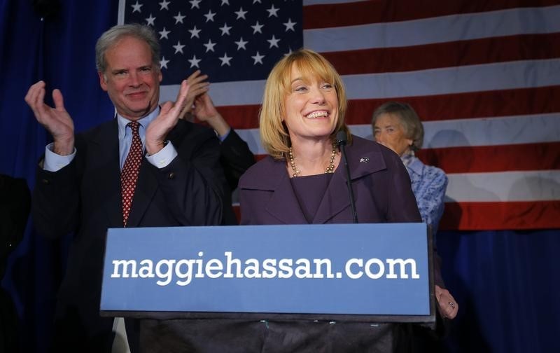 © Reuters. Democratic New Hampshire Governor Maggie Hassan celebrates her re-election with her husband Tom at her side at her election night rally in Manchester