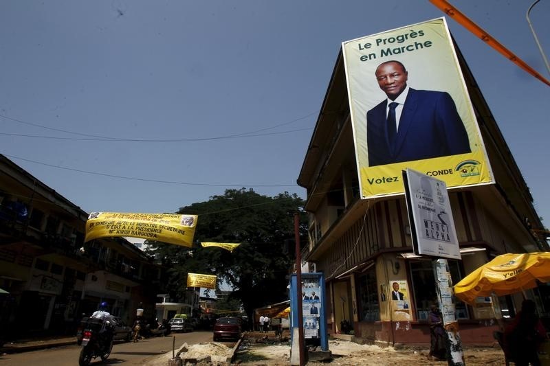 © Reuters. A poster of Guinea's outgoing president and presidential candidate Alpha Conde, leader of Rassemblement du Peuple de Guinea (RPG) is seen at a junction of Kaloum in Conakry