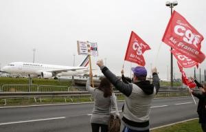 © Reuters. Striking employees of Air France demonstrate in front of the Air France headquarters building at the Charles de Gaulle International Airport in Roissy