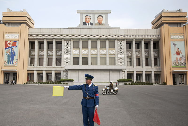 © Reuters. A policeman directs traffic at Kim Il Sung Stadium before North Korea's preliminary 2018 World Cup and 2019 AFC Asian Cup qualifying soccer match against Philippines in Pyongyang