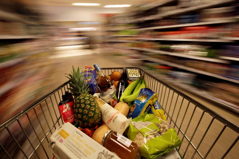 © Reuters. A shopping trolley is pushed around a supermarket in London