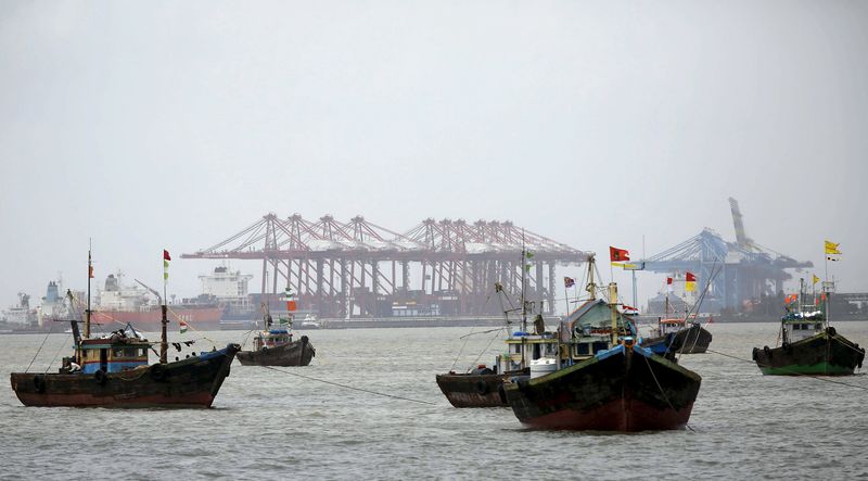 © Reuters. File photo shows fishing trawlers in front of JNPT in Mumbai