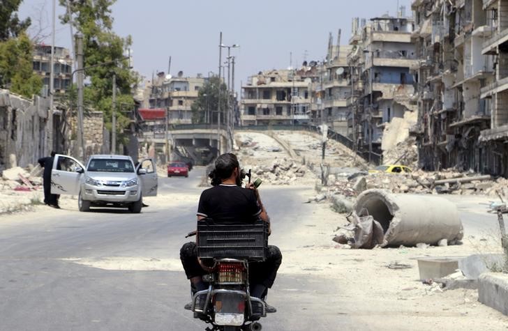 © Reuters. Rebeldes passam perto de ponte Al-Shaar, em Aleppo