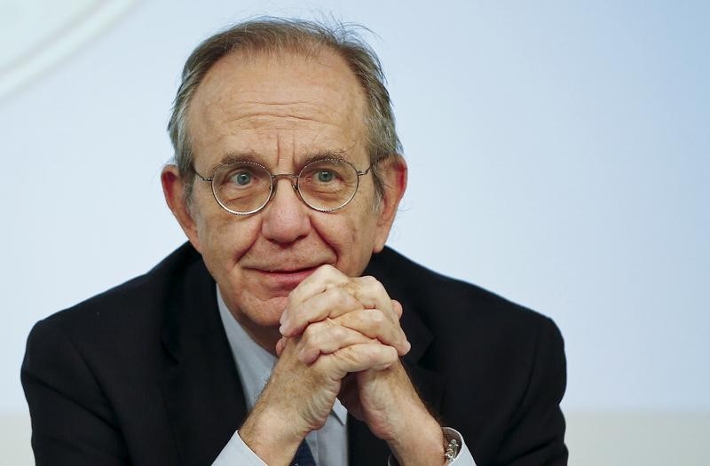 © Reuters. Padoan listens to a reporter's question during a news conference in Rome