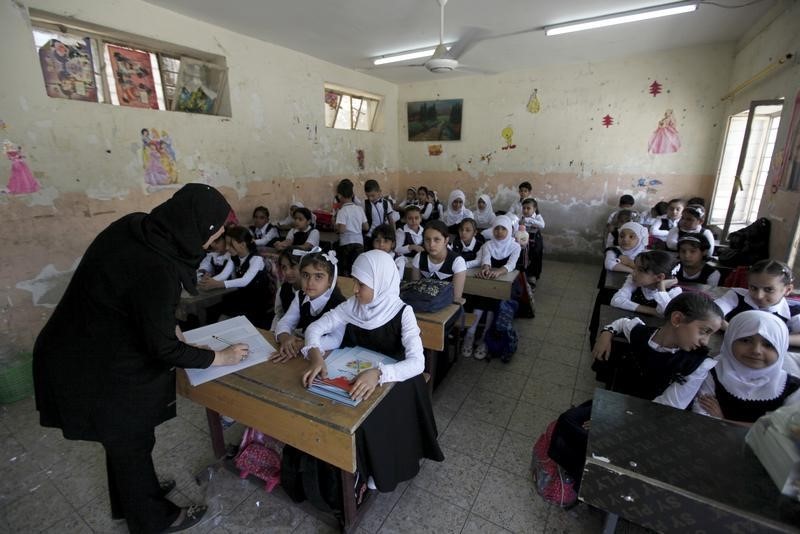 © Reuters. Students attend the first day of the new school term in Baghdad 