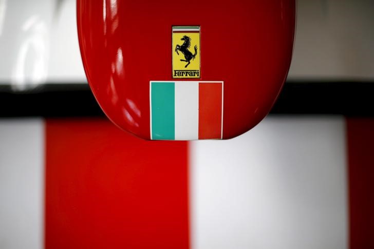 © Reuters. A Ferrari logo and a Italian flag are pictured on a replica of a Ferrari Formula One car in Santiago city