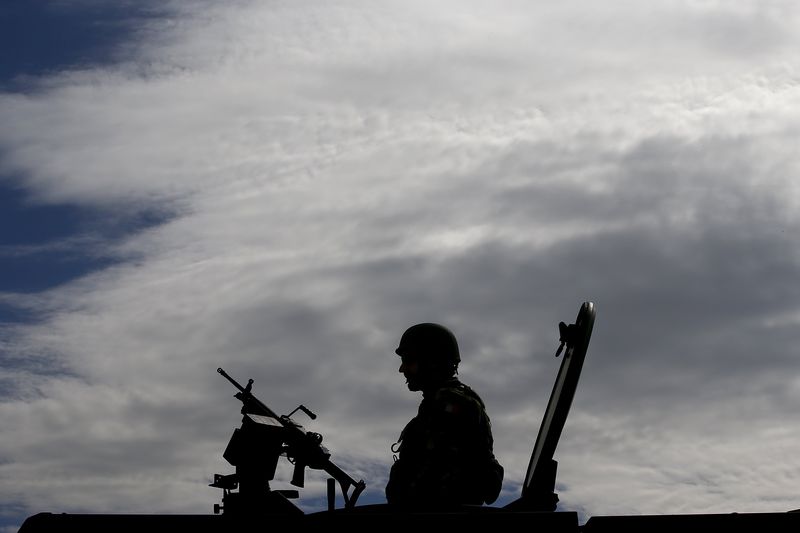 © Reuters. Italian soldier is silhouetted during a NATO military exercise at the Birgi NATO Airbase in Trapani