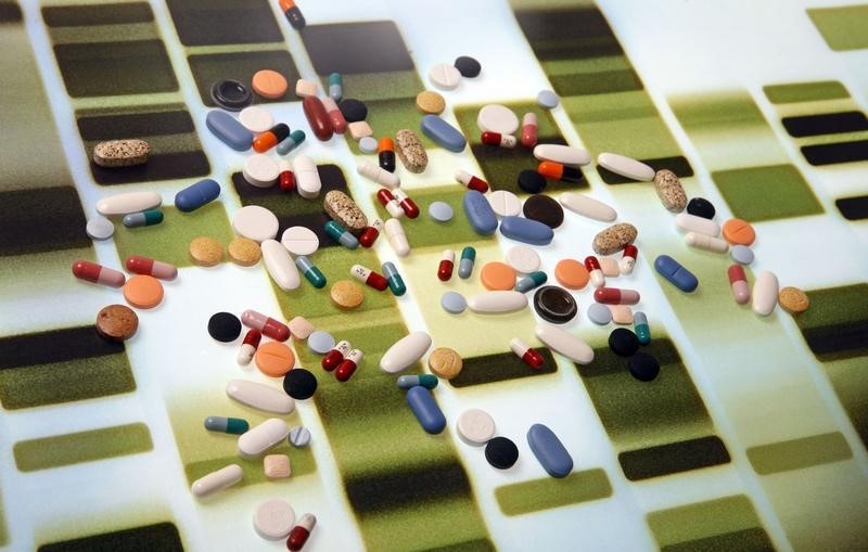 © Reuters. Pharmaceutical tablets and capsules are arranged on a background printed with a DNA pattern in this picture illustration taken in Ljubljana