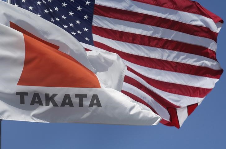 © Reuters. A flag with the Takata logo flies alongside an American flag outside the Takata Corporation in Auburn Hills