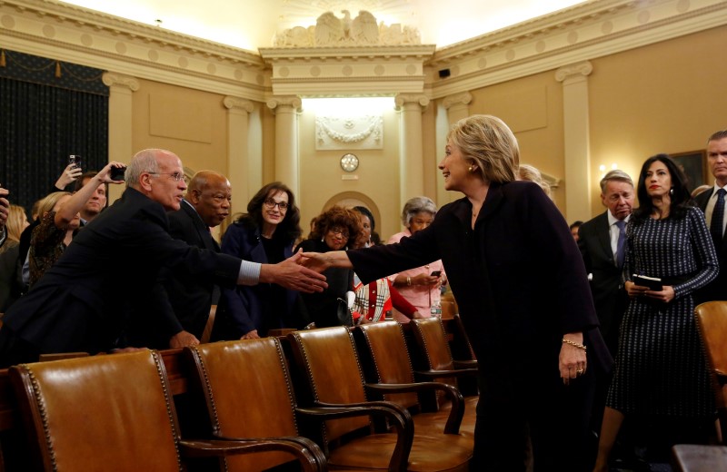 © Reuters. Democratic presidential candidate Hillary Clinton shakes hands with Rep. Peter Welch after concluding her first round of testimony in front of the House Select Committee on Benghazi on Capitol Hill in Washington 