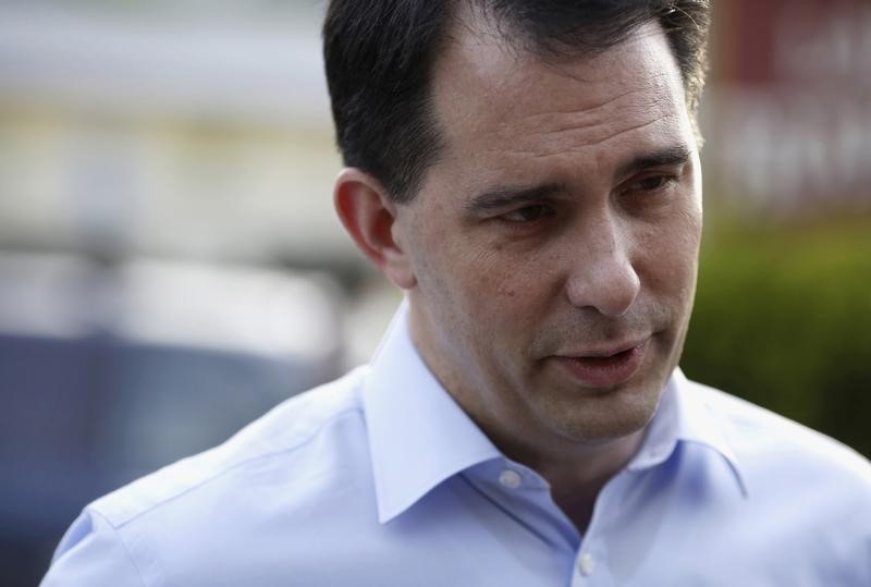 © Reuters. Wisconsin Governor Scott Walker speaks to a reporter before a sunset cruise with the Belknap County Republicans in Laconia