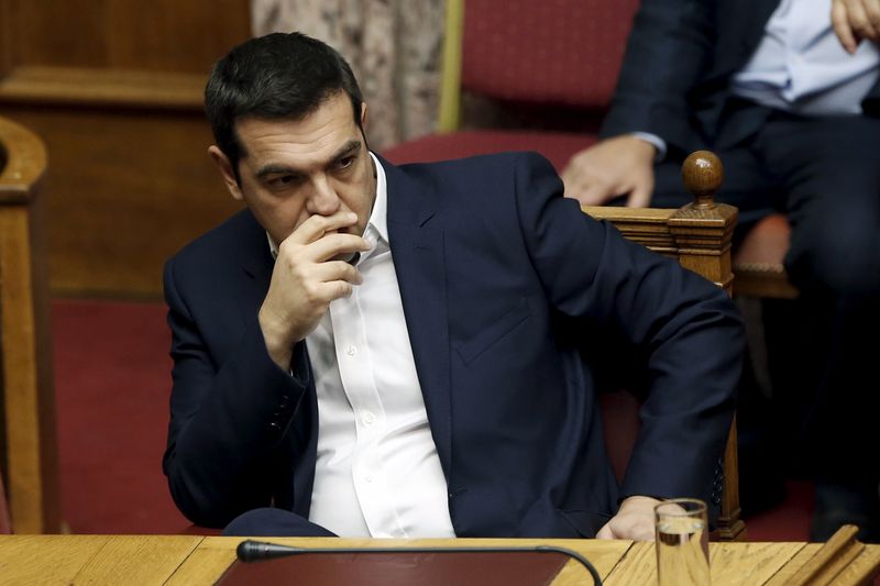 © Reuters. Greek Prime Minister Alexis Tsipras attends a parliamentary session before a vote on an omnibus bill at the parliament in Athens