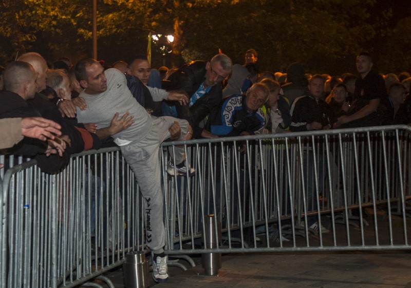 © Reuters. A protester tries to cross a barricade during protests in front of the parliament building in Podgorica, Montenegro