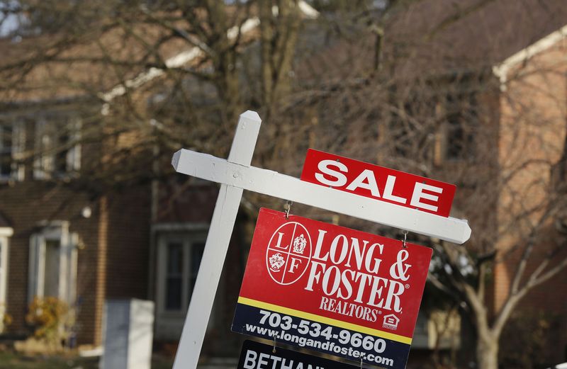 © Reuters. File photo of a home for sale sign in front of a house in Oakton Virginia