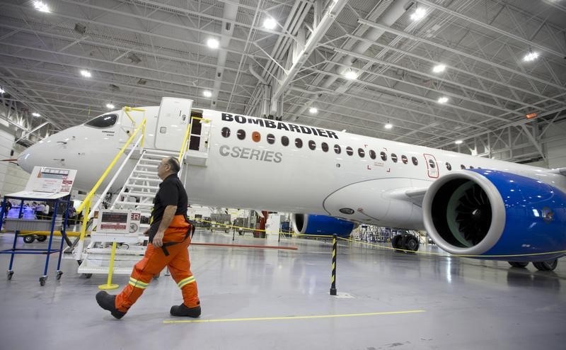 © Reuters. A Bombardier worker walks past the CS300 Aircraft in the hangar prior to its' test flight in Mirabel, Quebec