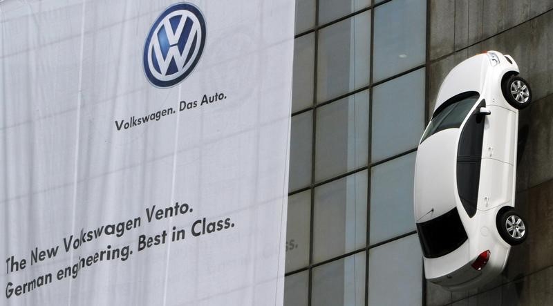 © Reuters. The new Volkswagen's "Vento" car hangs on display from a building during its launch in New Delhi