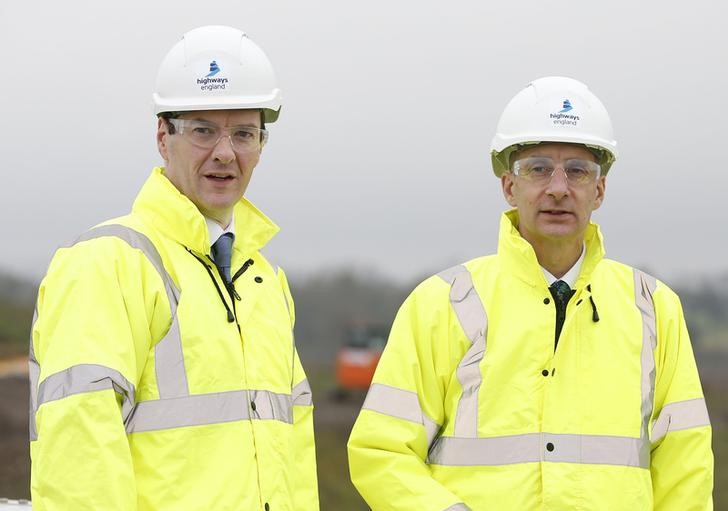 © Reuters. Britain's Chancellor of the Exchequer George Osbourne (L) and Lord Adonis visit a A1 road widening site after launching the National Infrastructure Commission at the National Railway Museum in York, northern England