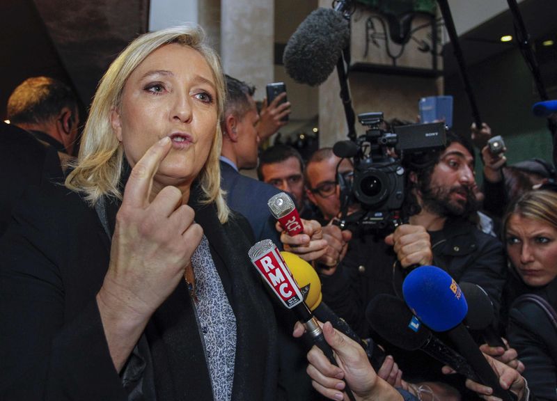 © Reuters. French National Front political party leader Marine Le Pen speaks to journalists as she leaves the courthouse in Lyon