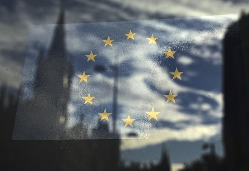 © Reuters. The European Union flag is pictured in a window reflecting a street in London