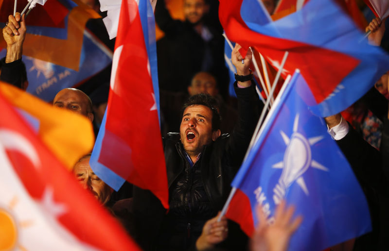 © Reuters. People wave flags outside the AK Party headquarters in Ankara