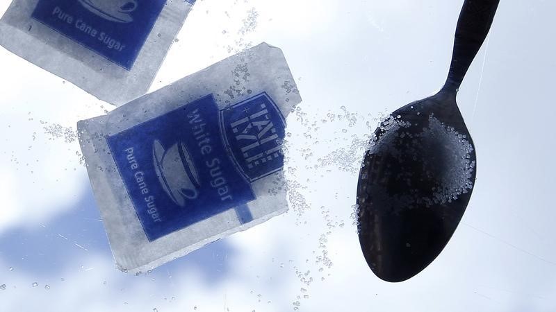 © Reuters. Sachets of Tate and Lyle sugar are seen on a glass table outside a coffee shop in Belfast