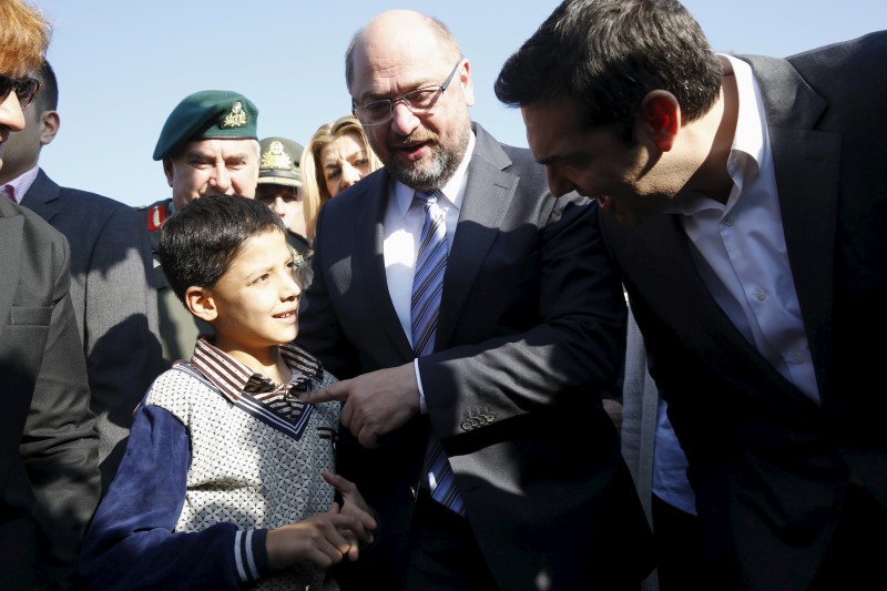 © Reuters. Schulz (à esquerda) e Tsipras cumprimentam menino refugiado na ilha de Lesbos