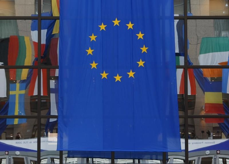 © Reuters. Flags are reflected in a window at the European Council building in Brussels