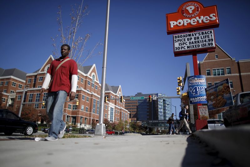 © Reuters. A man walks by a popeyes restaurant a cross the street from the John Hopkins Hospital in Baltimore, Maryland