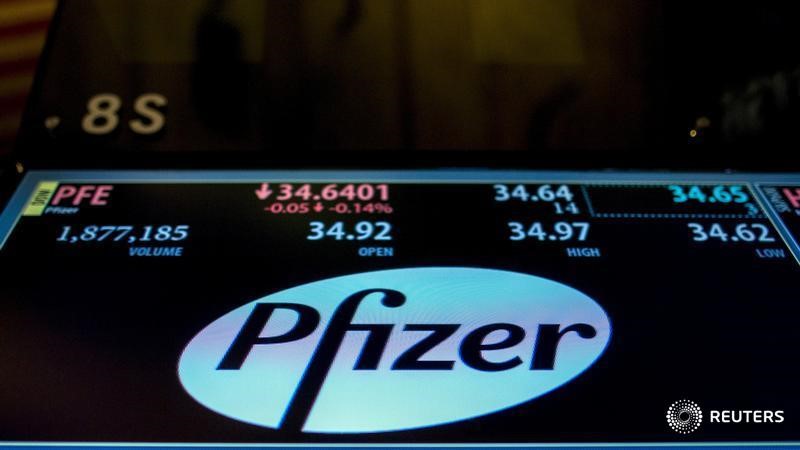 © Reuters. The ticker information for Pfizer is displayed on a screen above the post where it's traded on the floor of the New York Stock Exchange 