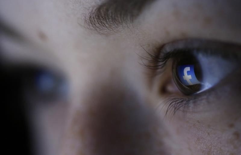 © Reuters. A picture illustration shows a Facebook logo reflected in a person's eye, in Zenica