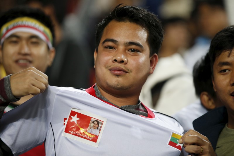 © Reuters. Portrait of Myanmar's National League for Democracy party leader Aung San Suu Kyi is seen on the shirt of a supporter during the World Cup qualifying soccer match between South Korea and Myanmar at the Suwon World Cup stadium in Suwon