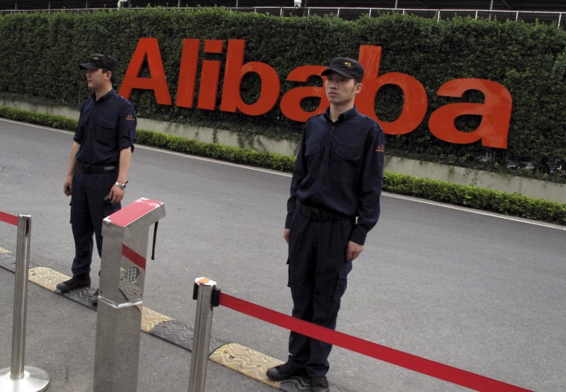 © Reuters. File picture of guards standing near an entrance to Alibaba's headquarters in Hangzhou