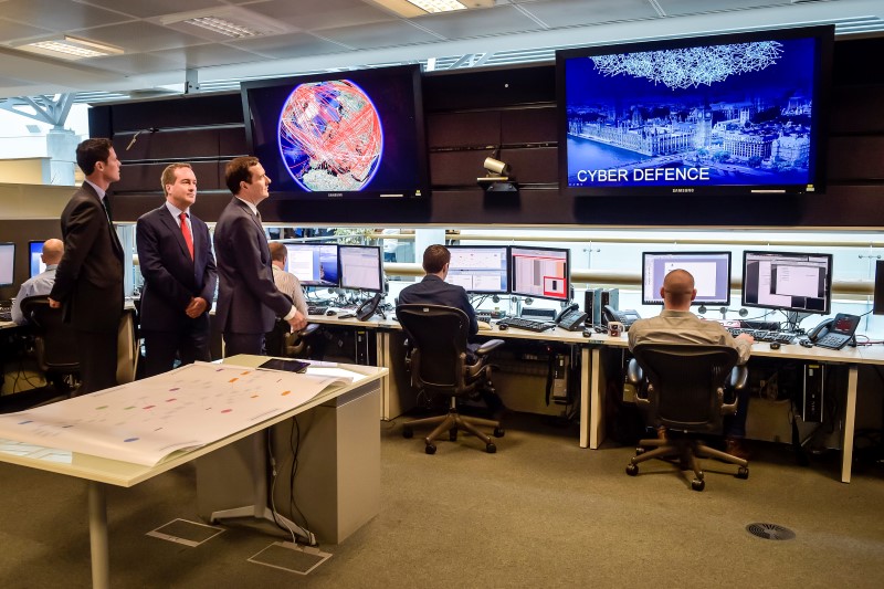 © Reuters. Britain's Chancellor of the Exchequer George Osborne is shown the 24 hour Operations Room inside GCHQ, by the Director of GCHQ Robert Hannigan (C) and Cheltenham MP Alex Chalk (L), in Cheltenham