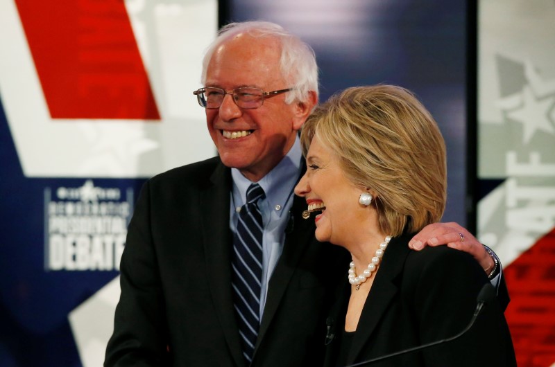 © Reuters. Democratic U.S. presidential candidate Clinton shares a laugh with Sanders at the conclusion of the second official 2016 U.S. Democratic presidential candidates debate in Des Moines