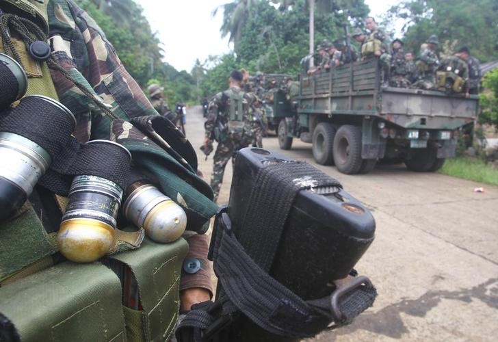 © Reuters. Soldiers stand guard on a road as they are deployed to remote villages in Jolo