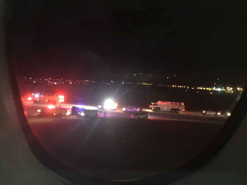 © Reuters. Emergency personnel are shown on the tarmac at Salt Lake City International Airport in this photograph taken by passenger Keith Rosso from a seat inside Air France flight 65