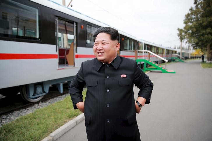 © Reuters. North Korean leader Kim Jong Un smiles as he looks at a newly manufactured metro train during a visit to the Kim Jong Thae Electric Locomotive Complex in this undated photo released by North Korea's KCNA in Pyongyang