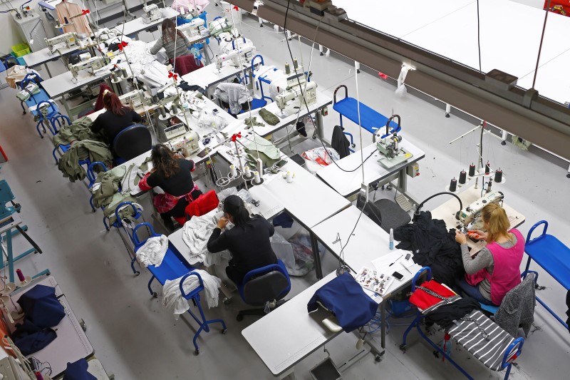 © Reuters. Women work on sewing machines at the Fashion Enter factory in London 
