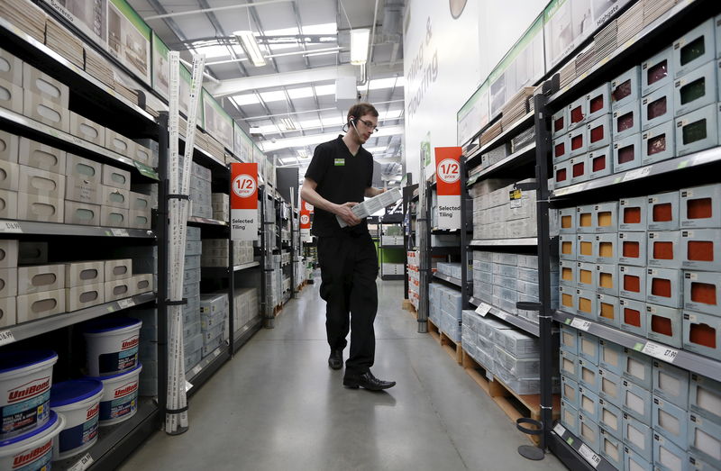 © Reuters. File photo of a sales assistant carrying tiles at a Homebase store in Aylesford 