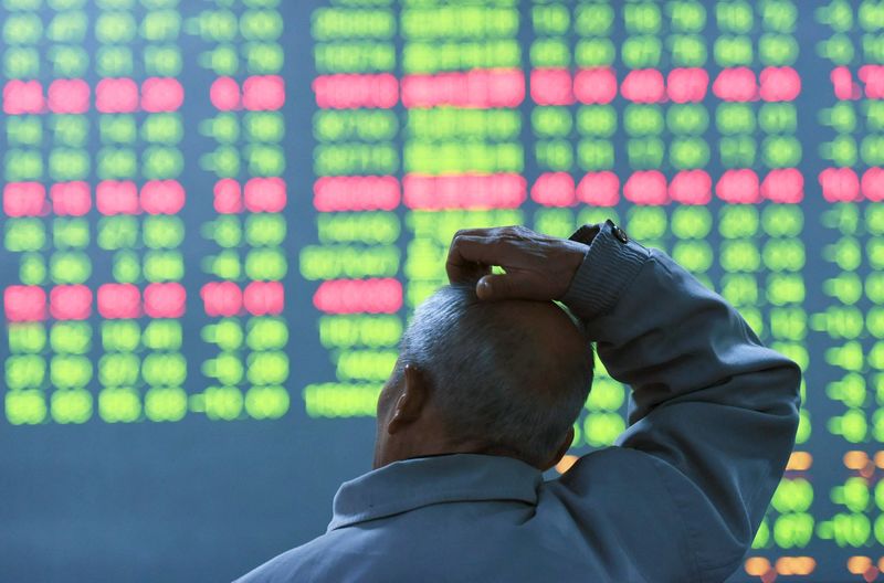 © Reuters. An investor looks at an electronic screen showing stock information at brokerage house in Hangzhou