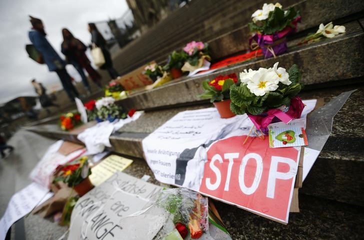 © Reuters. Flowers and posters are placed in the square between the city cathedral and the railway station in Cologne