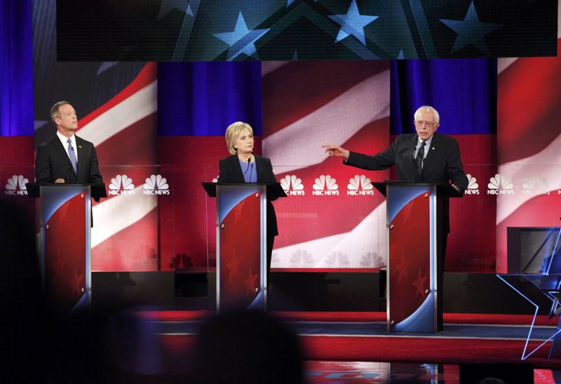 © Reuters. Democratic U.S. presidential candidate and U.S. Senator Bernie Sanders speaks as former Governor Martin O'Malley and former Secretary of State Hillary Clinton listen at the NBC News - YouTube Democratic presidential candidates debate in Charleston