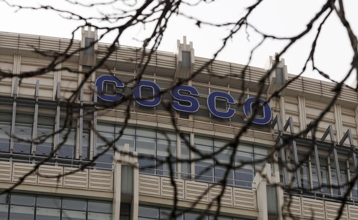 © Reuters. A sign COSCO is seen behind tree branches atop of the company's headquarters in Beijing