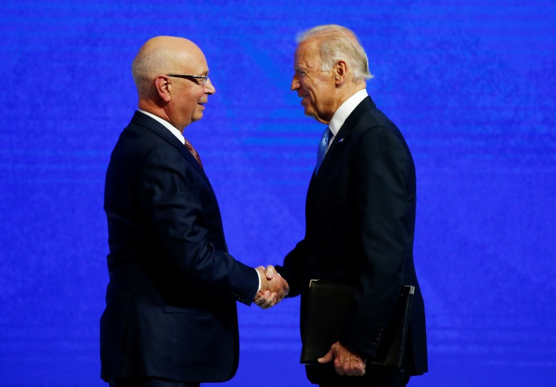 © Reuters. US Vice President Biden shakes hand with WEF founder Schwab before his address at the Annual Meeting of the WEF in Davos