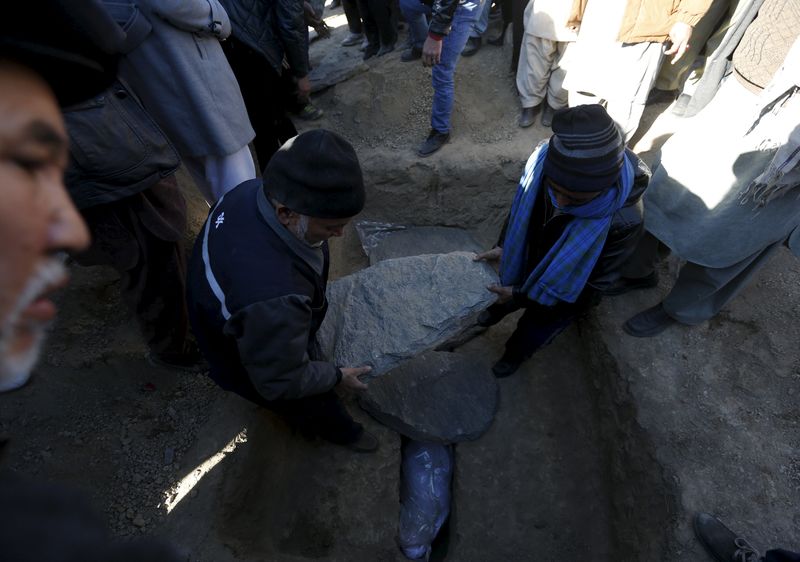 © Reuters. Afghans take part in a burial ceremony for one of the victims of last night suicide car bomb attack in Kabul, Afghanistan 